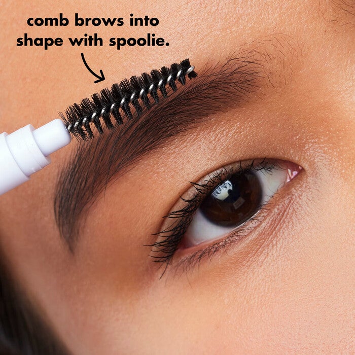 Model Using Spoolie to Shape Brows