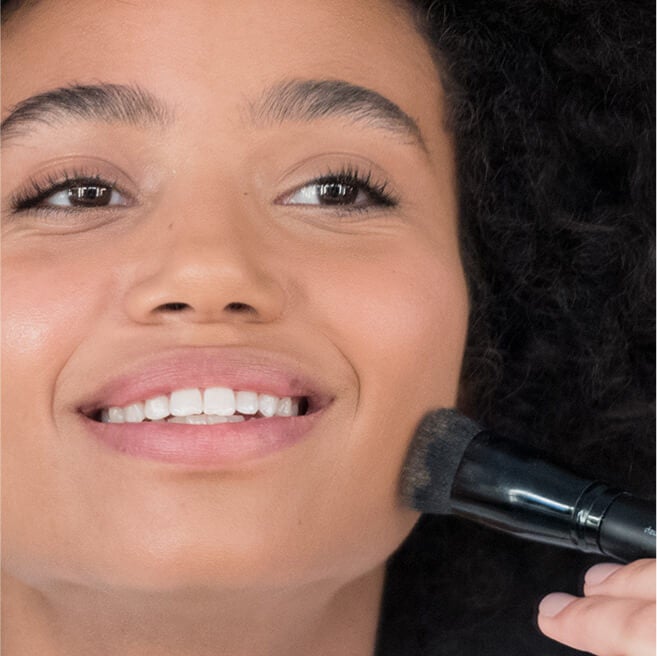 model applying foundation mix on face